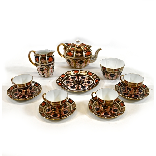 554 - A part tea set by Royal Crown Derby comprising teapot, milk jug, sugar bowl, sandwich plate, four cu... 