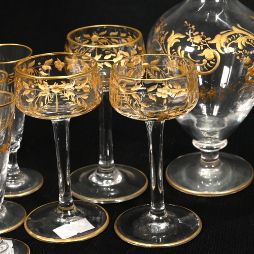 562 - A pair of slender teardrop shaped 19th century continental liqueur or cordial decanters with gilt en... 