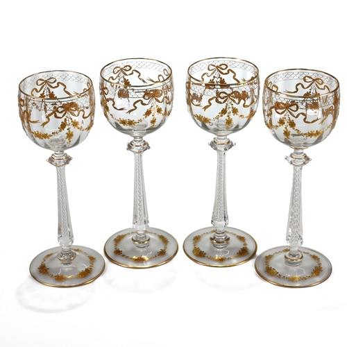 563 - A set of four Moser hock glasses with air twist stems, decorative Puginesque knops and gilt floral s... 