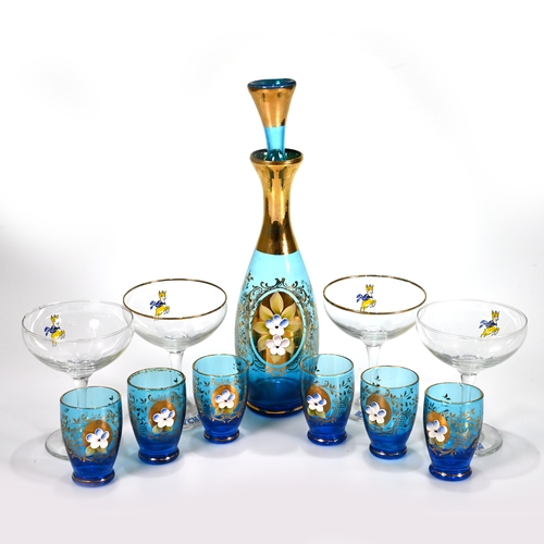 565 - A Moser blue glass decanter with stopper (29cm) and six cordial/liqueur glasses (6.8cm), with gilt s... 