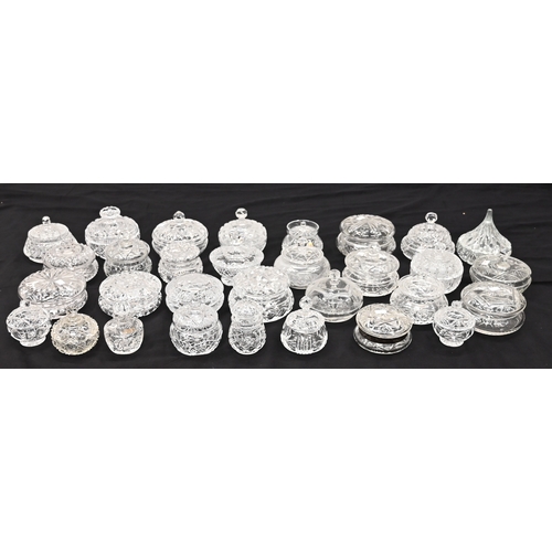 572 - A large quantity of cut glass dressing table jars with lids including one with hallmarked silver rim... 