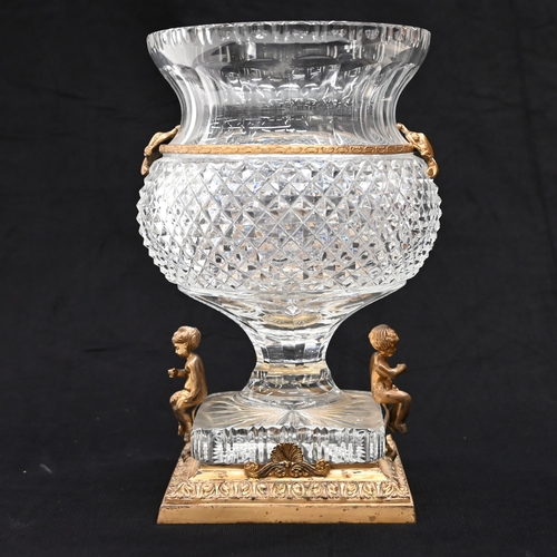 577 - A thistle head shaped Empire style crystal glass urn with a square base raised on a gilt brass stand... 