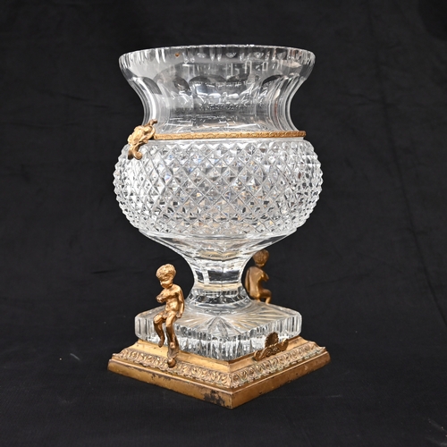 577 - A thistle head shaped Empire style crystal glass urn with a square base raised on a gilt brass stand... 