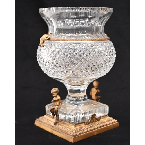 577 - A thistle head shaped Empire style crystal glass urn with a square base raised on a gilt brass stand... 