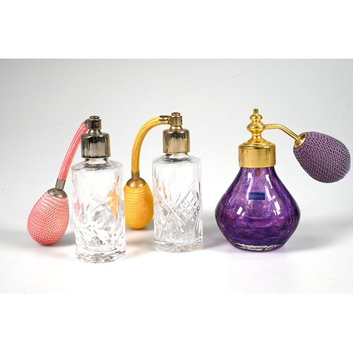 579 - Three glass atomisers, two clear and one purple, a frosted glass metal mounted perfume bottle, a pai... 