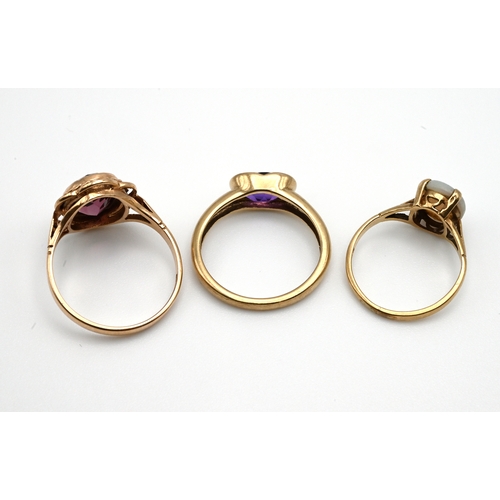 81 - A 9 carat gold single stone opal ring; with two 9 carat gold amethyst dress rings, 7 grams gross.