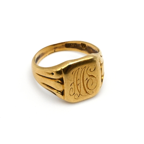 92 - An inscribed signet ring, stamped ‘750’, 2.8 grams gross.