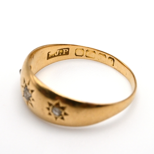 93 - An 18 carat gold ring, star set with three small diamonds, finger size L 1/2, 2.7 grams gross.