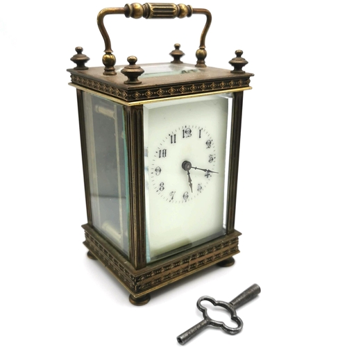 658 - 19th Century French brass carriage clock with key. H 13cm, W 7.5cm.