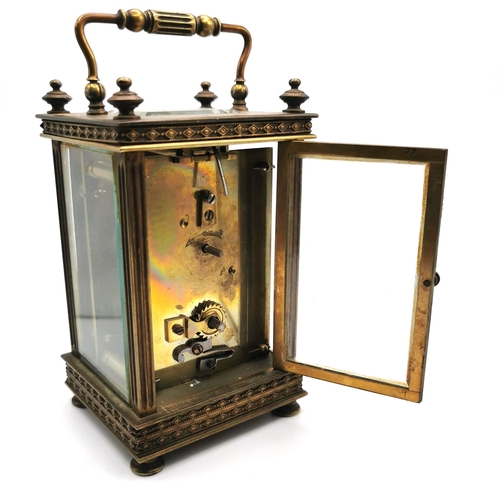 658 - 19th Century French brass carriage clock with key. H 13cm, W 7.5cm.