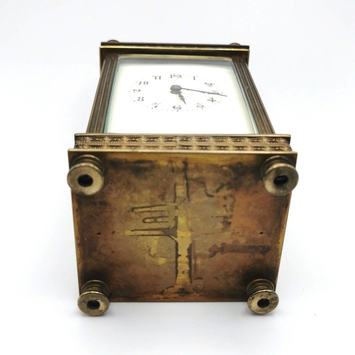 658 - 19th Century French brass carriage clock with key. H 13cm, W 7.5cm.