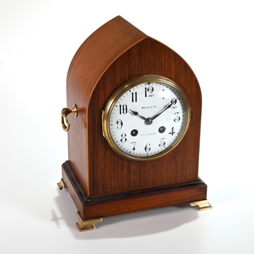 665 - A late 19th Century Lancet shaped mantle clock in mahogany case supported on brass bracket feet and ... 