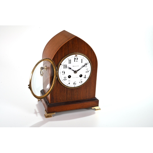 665 - A late 19th Century Lancet shaped mantle clock in mahogany case supported on brass bracket feet and ... 