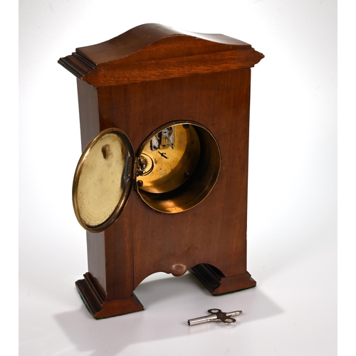 666 - A neat mahogany cased mantle clock, circa 1900, inlaid with fruitwood swags, of unusual footed form,... 