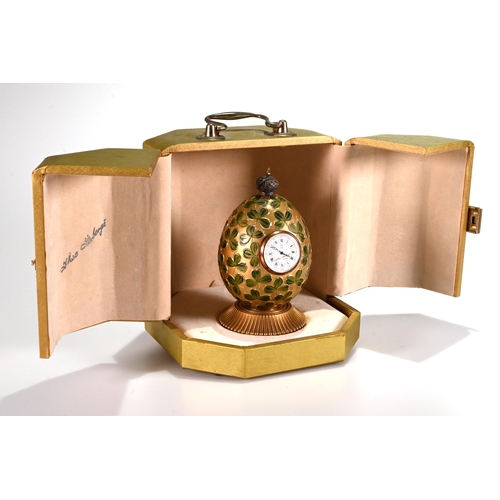 673 - A modern gilt metal and enamel clover Egg time piece by Theo Faberge, England, No. 254 of 750. The e... 