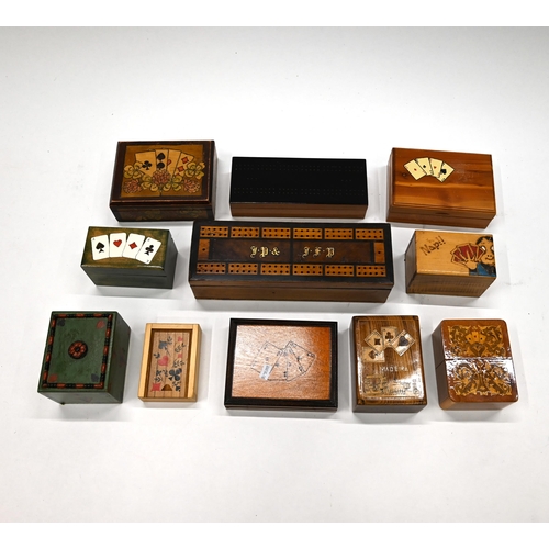 680 - A collection of 20th Century treen boxes including two cribbage boards, one containing dominoes and ... 