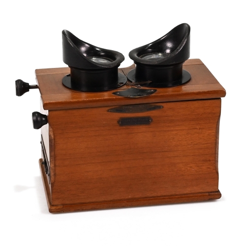 703 - A Unis of France Standard Stereoscope in Walnut case with bakelite eye pieces c1920s. Retailers plaq... 