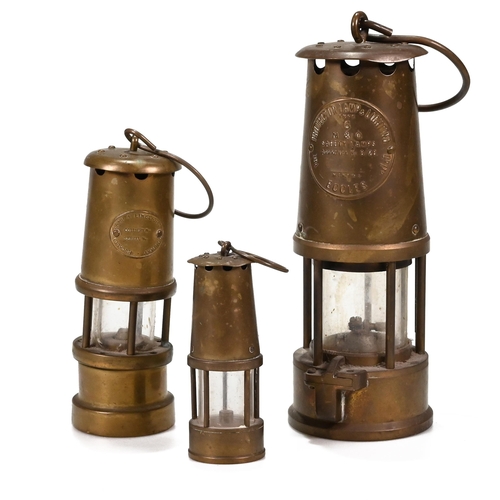 707 - Three brass miner's lamps the tallest 23cm by Eccles, the next 17cm by the Lamp & Limelight Co, Hock... 