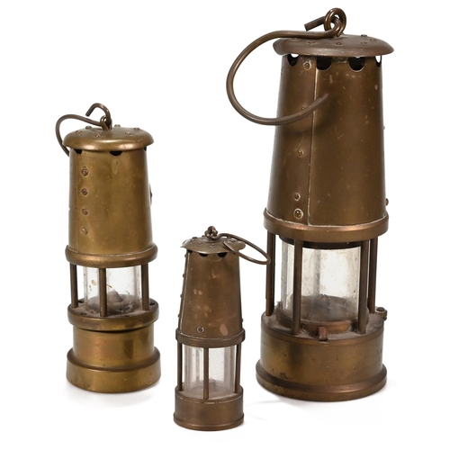 707 - Three brass miner's lamps the tallest 23cm by Eccles, the next 17cm by the Lamp & Limelight Co, Hock... 