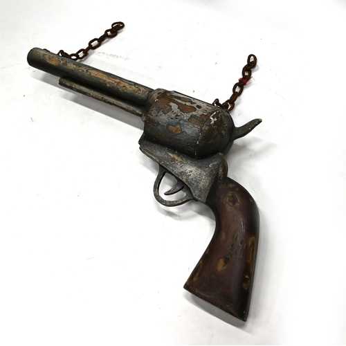 713 - A large carved and painted wooden advertising six shooter pistol bearing the name E.M.Reilly New Oxf... 