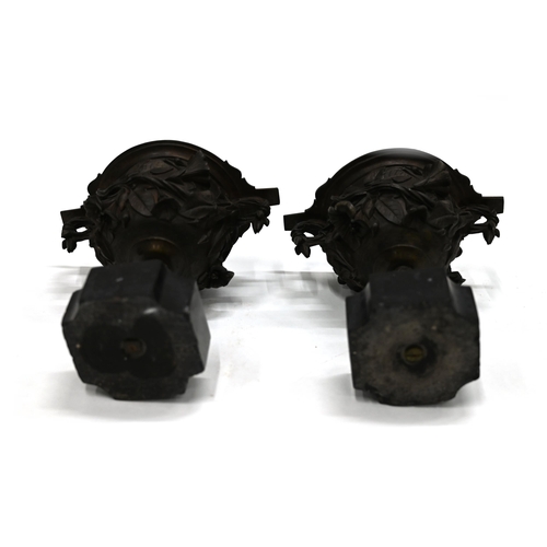 725 - A pair of 19th Century Grand Tour bronze two handled drinking cups mounted on square marble socles w... 