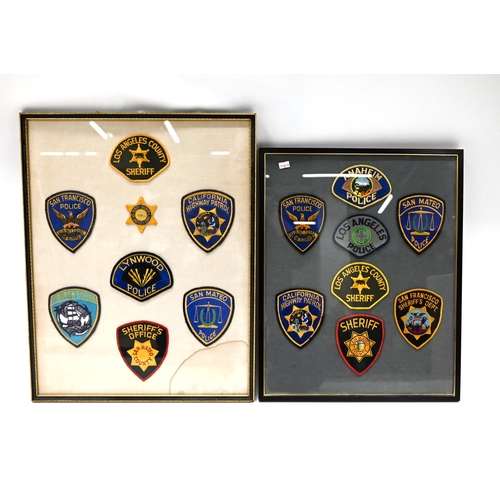 753 - A group of 32 vintage US embroidered Police patches mounted within four matching frames. Largest Fra... 