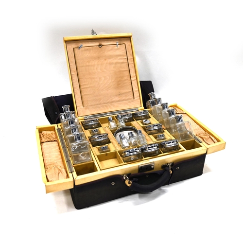 802 - A lady's travelling vanity case, by Drew & Sons of Piccadilly, with 27 glass containers with white m... 