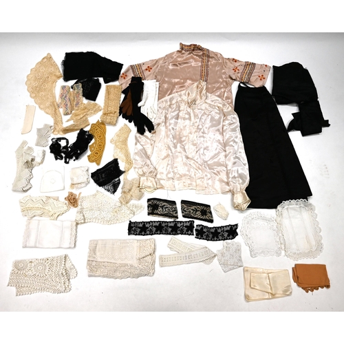 863 - A quantity of 19th century and later textiles including a pink blouse with chain stitching, a cream ... 