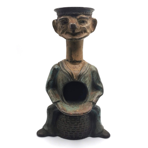 882 - An early 20th Century cast iron novelty nutcracker titled ' Tough Nut' in the form of a sailor sitti... 