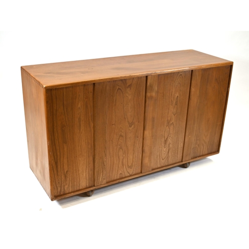 909 - A classic Mid Century Ercol Elm Windsor Sideboard. Larger cupboard  fitted with adjustable height sh... 