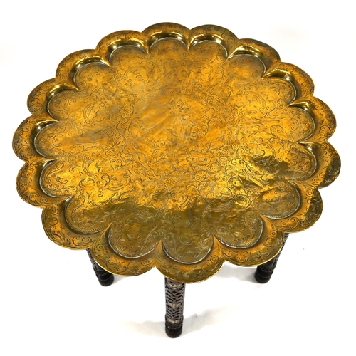 913 - An antique Indian Benares table with a scallop-edged brass top intricately chased with scrollwork an... 