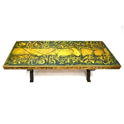 919 - A mid 20th Century Coffee table with steel strap legs and wood and resin top. This reputedly depicts... 