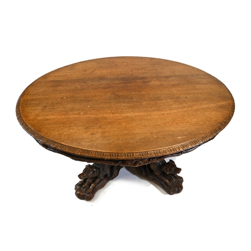 929 - A large Black Forest Hunt Centre Table, c1880s. Constructed in Oak the base has been carved as four ... 