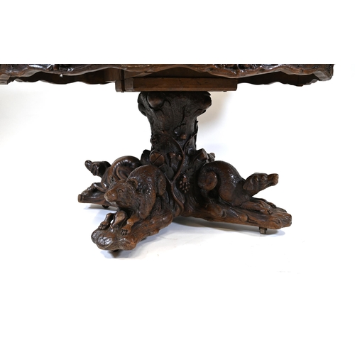 929 - A large Black Forest Hunt Centre Table, c1880s. Constructed in Oak the base has been carved as four ... 