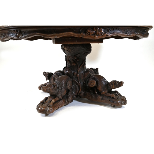 929 - A large Black Forest Hunt Centre Table, c1880s. Constructed in Oak the base has been carved as four ... 