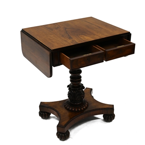 935 - A William IV Rosewood drop leaf table. The rectangular top extending each side with flaps with round... 