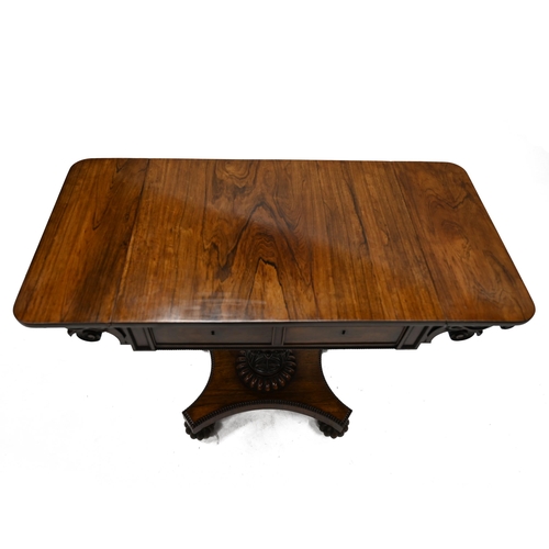 935 - A William IV Rosewood drop leaf table. The rectangular top extending each side with flaps with round... 