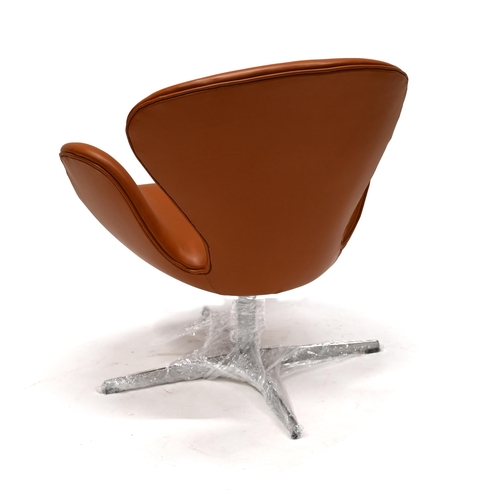 944 - Fritz Hansen Swan Chair in Tan Leather with polished aluminium swivel base. This example manufacture... 