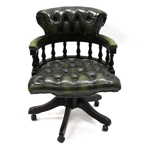 962 - A green leather and dark wood Captain's Chair supported on five legs, with casters, to a swivel and ... 