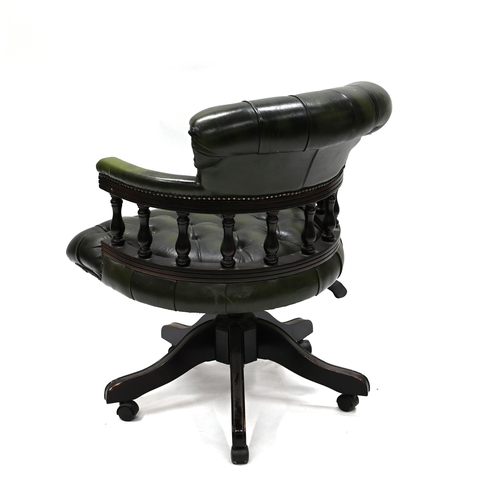 962 - A green leather and dark wood Captain's Chair supported on five legs, with casters, to a swivel and ... 