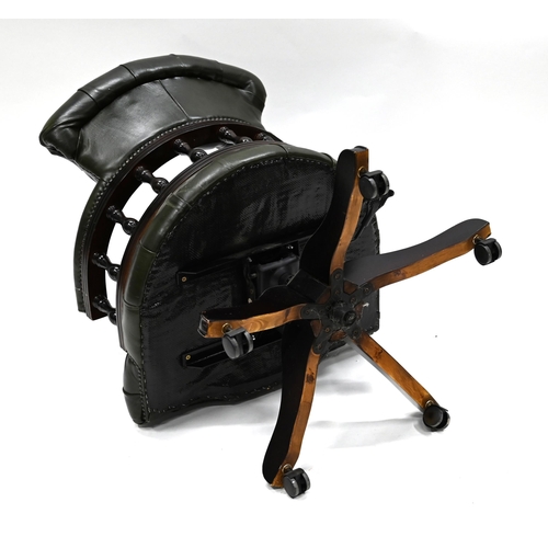 962 - A green leather and dark wood Captain's Chair supported on five legs, with casters, to a swivel and ... 