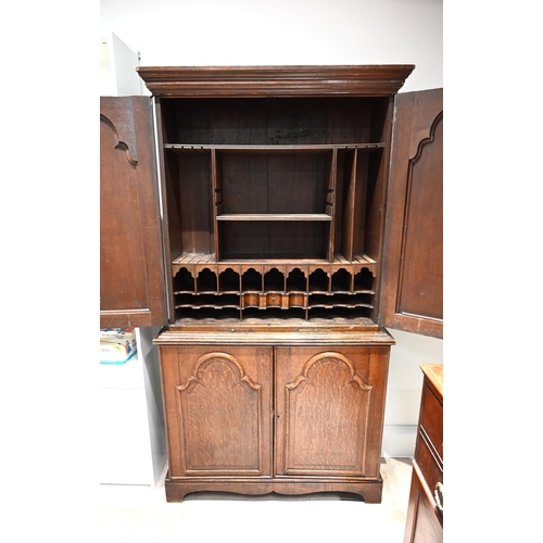 976 - A late Georgian Clerks Cupboard in solid oak with fielded panel doors and brass escutcheons. Upper f... 