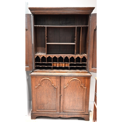 976 - A late Georgian Clerks Cupboard in solid oak with fielded panel doors and brass escutcheons. Upper f... 