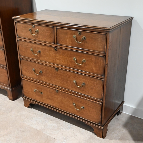 992 - A late Georgian Oak chest of 2 over 3 drawers with brass handles.  W 100cm, D 51cm, H 102cm.