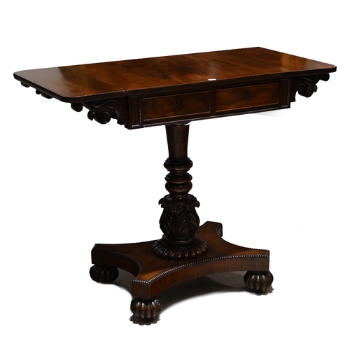 935 - A William IV Rosewood drop leaf table. The rectangular top extending each side with flaps with round... 