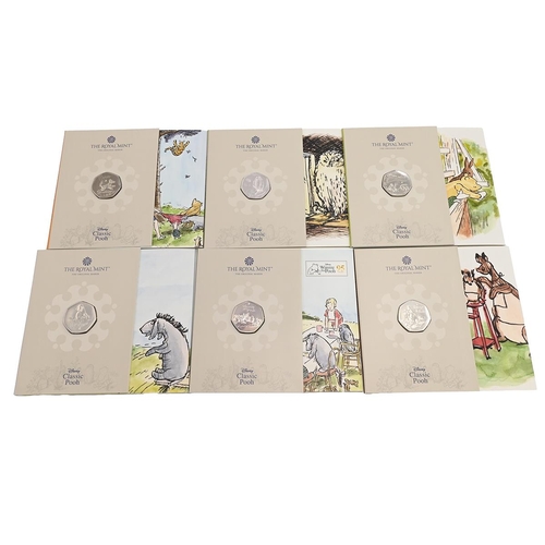 114 - Group of six (6) Winnie the Pooh official Royal Mint brilliant uncirculated 50p coins in original pa... 