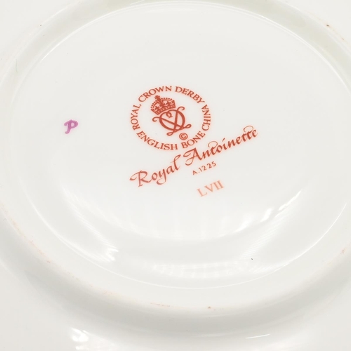 200 - A Royal Crown Derby Royal Antoinette pattern cup and saucer and a pair of  Royal Crown Derby cutlery... 