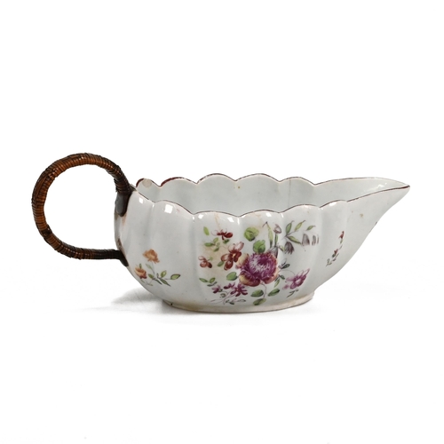 222 - A Derby sauceboat, circa 1760, with scalloped rim, fluted sides, floral decoration to bowl's inner a... 