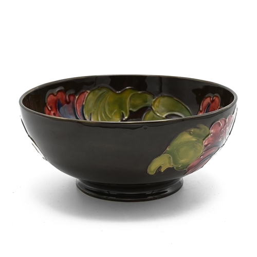 227 - Moorcroft flambe Hibiscus bowl with unusual brown ground, signed WM to base with impressed Moorcroft... 