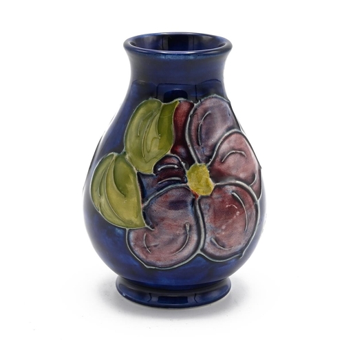 247 - Moorcroft - mid 20th Century blue ground posy vase with Clematis pattern. Impressed mark. Height 9.5... 